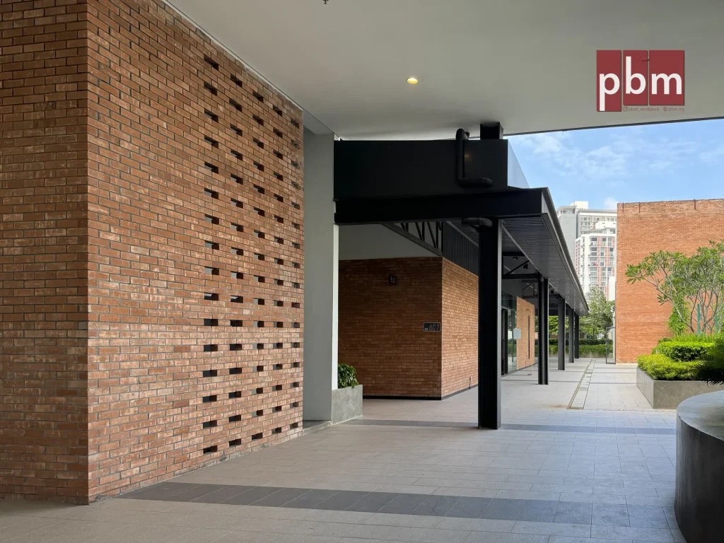 Rooftop corridor at EmHub with exposed brick ventilation wall